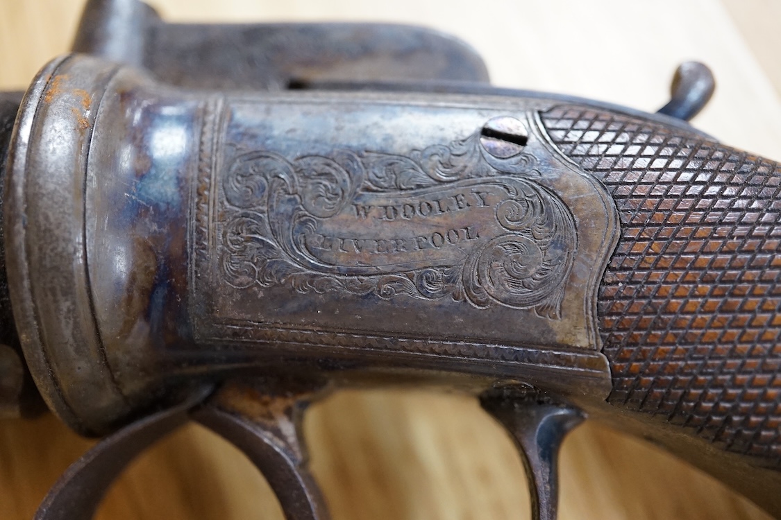 A six shot 80 bore, self-cocking, pepperbox revolver signed; W. Dooley, Liverpool, with foliate engraved frame and fluted barrel, Birmingham proved, and one piece rounded chequered walnut grip, together with a small copp